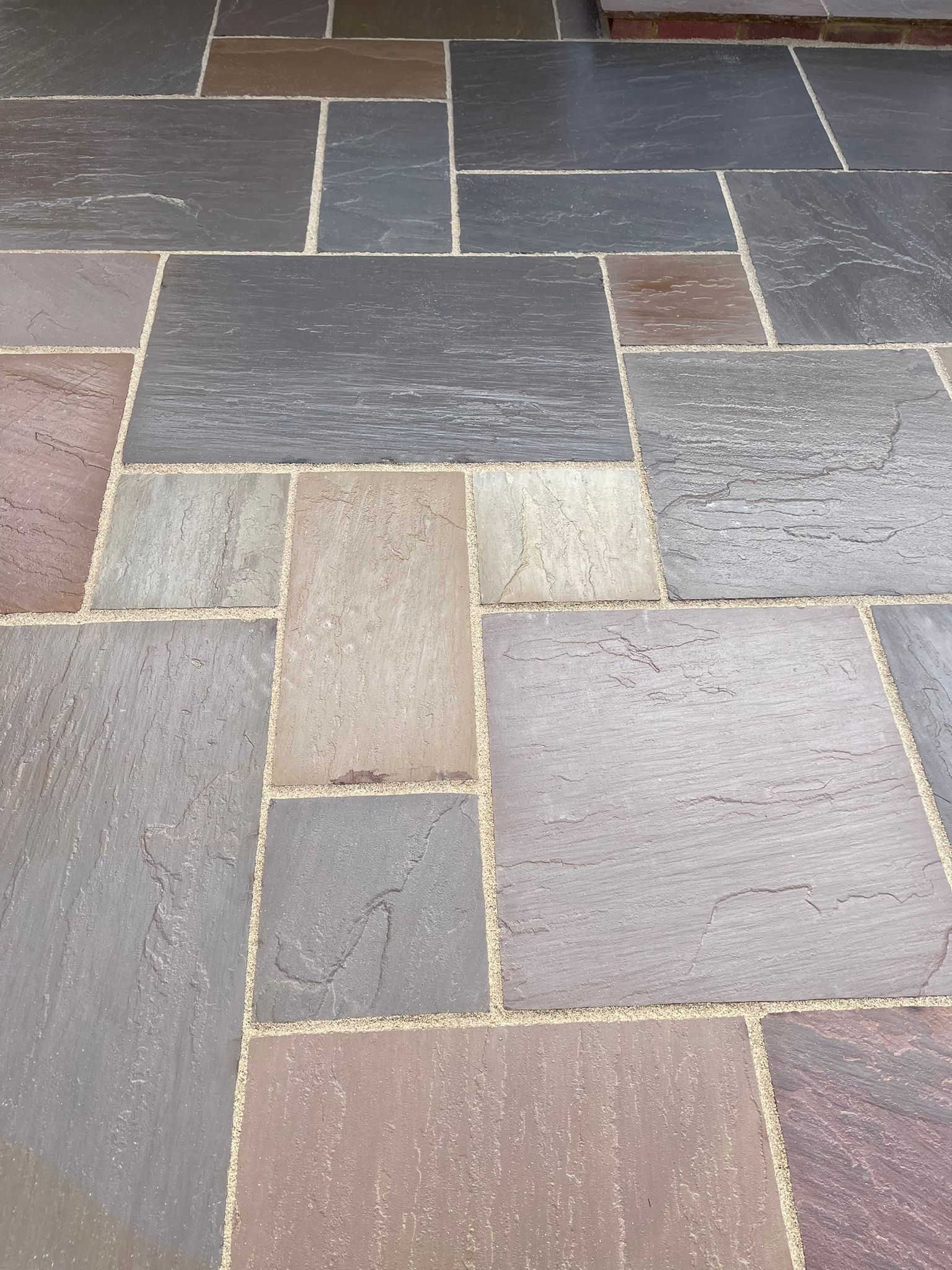 Modern porcelain patio with structured planting in a Kent garden
